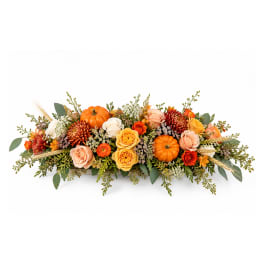 Autumn floral centerpiece with orange pumpkins and mixed roses