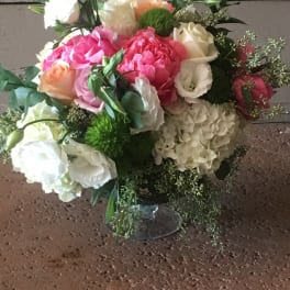 Mixed pink, white, and peach bouquet in a clear glass vase