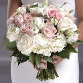 Handheld bouquet of pink and white roses with mixed blooms