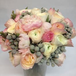 Bouquet of pale pink and cream flowers in a glass vase