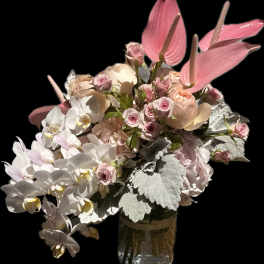 Pink and white floral arrangement in a glass vase