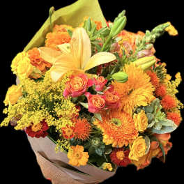 Bouquet of orange, yellow, and pink flowers wrapped in paper