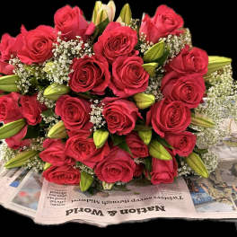 Bouquet of red roses with white filler and lily buds