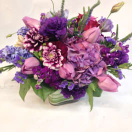 Purple and pink mixed bouquet in a glass vase