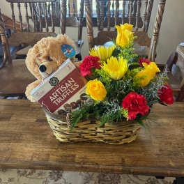 Gift basket with flowers, teddy bear, and chocolate truffles