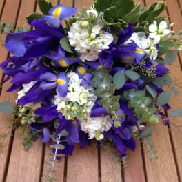 Bouquet of purple irises and white flowers with eucalyptus