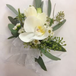 White orchid bouquet with greenery and a sheer ribbon