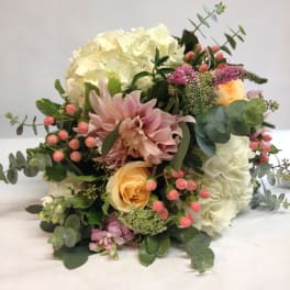 Bouquet of white and blush flowers with pink berries and eucalyptus
