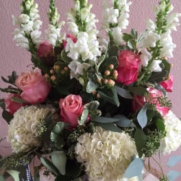 Pink roses and white snapdragons in a glass vase
