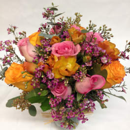 Bouquet of pink and orange roses in a glass vase