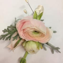 Pink ranunculus boutonniere with pale ribbon and pearl pins