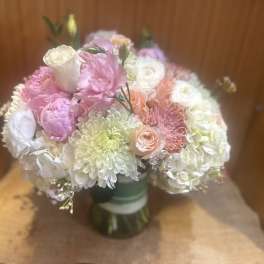 Bouquet of pink, white, and peach flowers in a glass vase