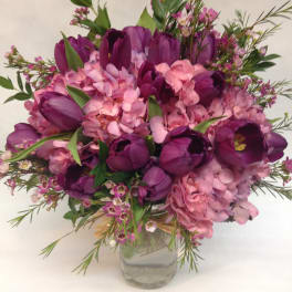 Purple tulips and pink hydrangeas in a glass vase