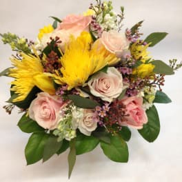 Bouquet of pink roses and yellow chrysanthemums with greenery