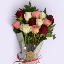 Bouquet of red, pink, and white roses wrapped in clear plastic