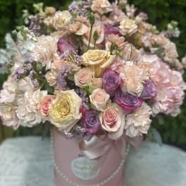 Pastel rose bouquet in a pink hatbox with ribbon