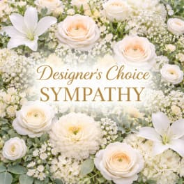 Soft white and cream roses, lilies, and mixed flowers with 'Designer’s Choice Sympathy' text in the center.