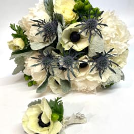 Cream bouquet with blue thistle and a matching boutonniere