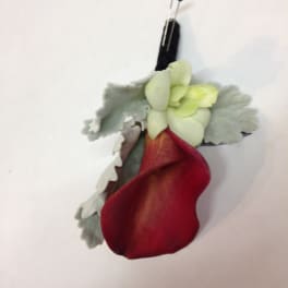 Red and pale green boutonniere with a black pin