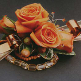 Orange rose corsage with ribbon and beaded accents