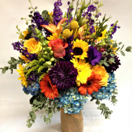 Colorful mixed bouquet in a burlap-wrapped vase