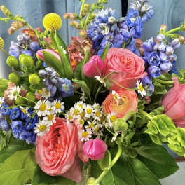Bouquet of pink roses, blue flowers, and white daisies
