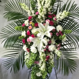 Tall standing floral spray with white lilies and pink flowers