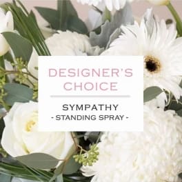White sympathy standing spray with mixed blooms and greenery