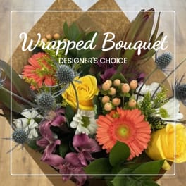 Wrapped bouquet with yellow roses, orange gerberas, and purple flowers