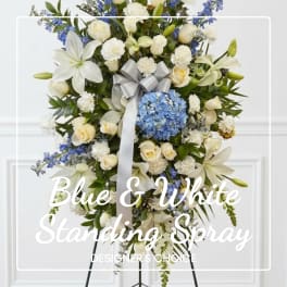Blue and white standing spray with roses, lilies, and hydrangea on an easel