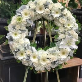 White floral wreath on a standing easel