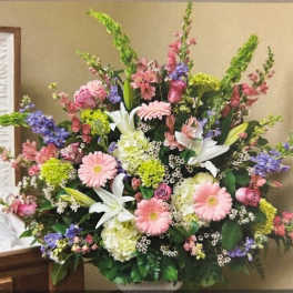 Large mixed floral arrangement with pink, white, purple, and green blooms