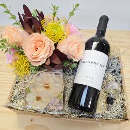Gift box with roses and a wine bottle