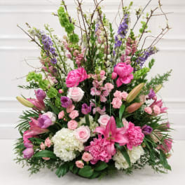 Large mixed floral arrangement with pink, purple, white, and green blooms