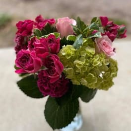 Bouquet of pink roses and green hydrangeas in a vase