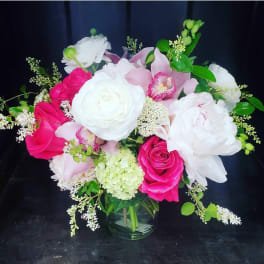 Pink and white floral bouquet in a glass vase