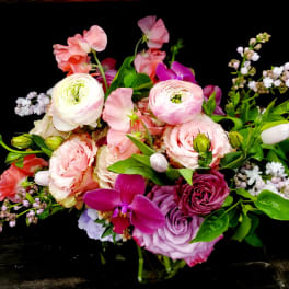 Mixed pink and purple bouquet with roses and ranunculus