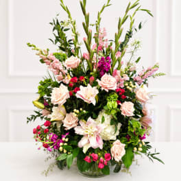 Large mixed bouquet of pink and white flowers in a glass vase