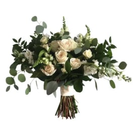 Bouquet of white roses and greenery tied at the stems