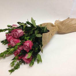 Bouquet of pink roses wrapped in burlap