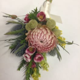Pink and green floral corsage with a large central bloom