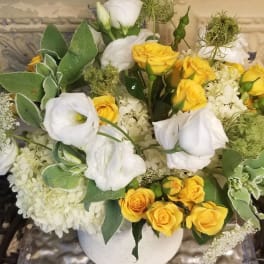 Yellow and white rose bouquet in a white vase