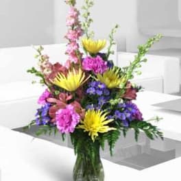 Colorful mixed flower arrangement in a glass vase
