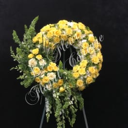 Yellow and white rose wreath on a standing easel