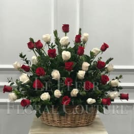 Basket arrangement of red and white roses