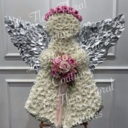 Angel-shaped floral arrangement with pink roses and silver wings