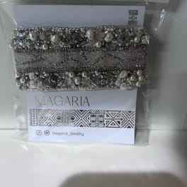 Beaded silver bracelet in a clear plastic package