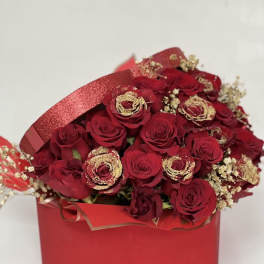 Red rose bouquet in a red gift box with gold accents