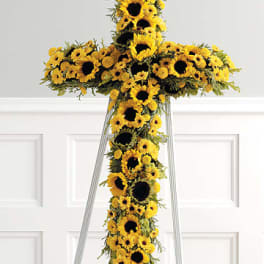 Yellow sunflower cross on a metal stand