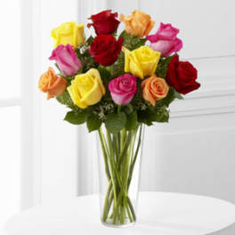 Bouquet of multicolored roses in a clear glass vase
